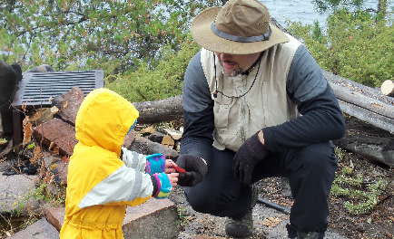 fishing guide helping a young child