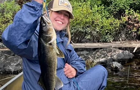 A woman holding a fish from the Bob Hitzeroth Party August 2024 Quetico